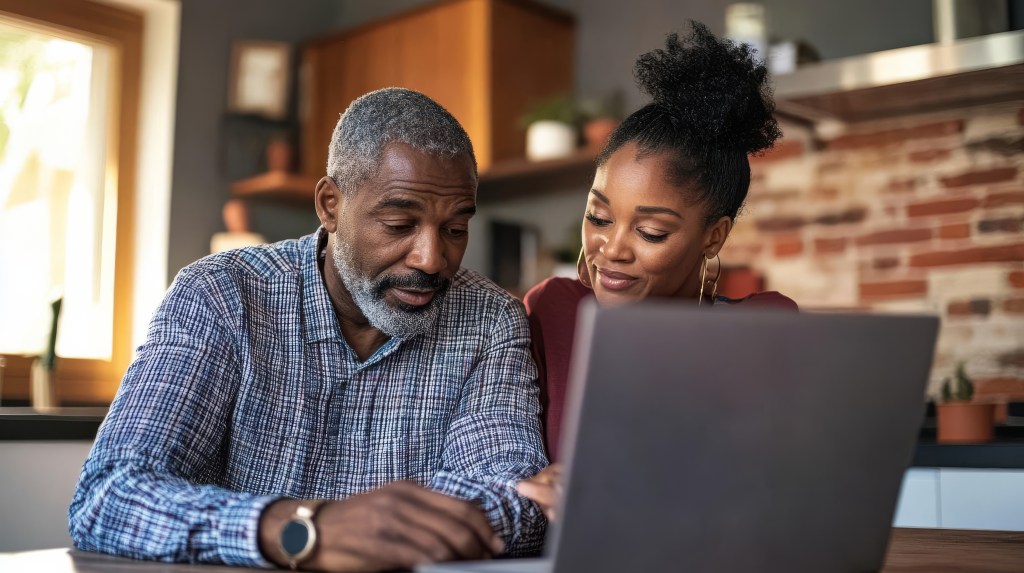 couple reviewing finances while deciding whether to pay off mortgage before retirement